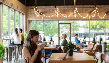 Businesswoman reviews document on laptop